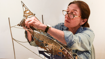 Artist Maria Artemis working on a small-scale version of Polytropos, UMD's sculpture