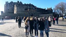 UMD LSBE student Courtney Cornelius in Scotland standing in front of a castle with other students.