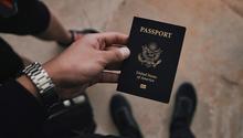 A hand holding a passport