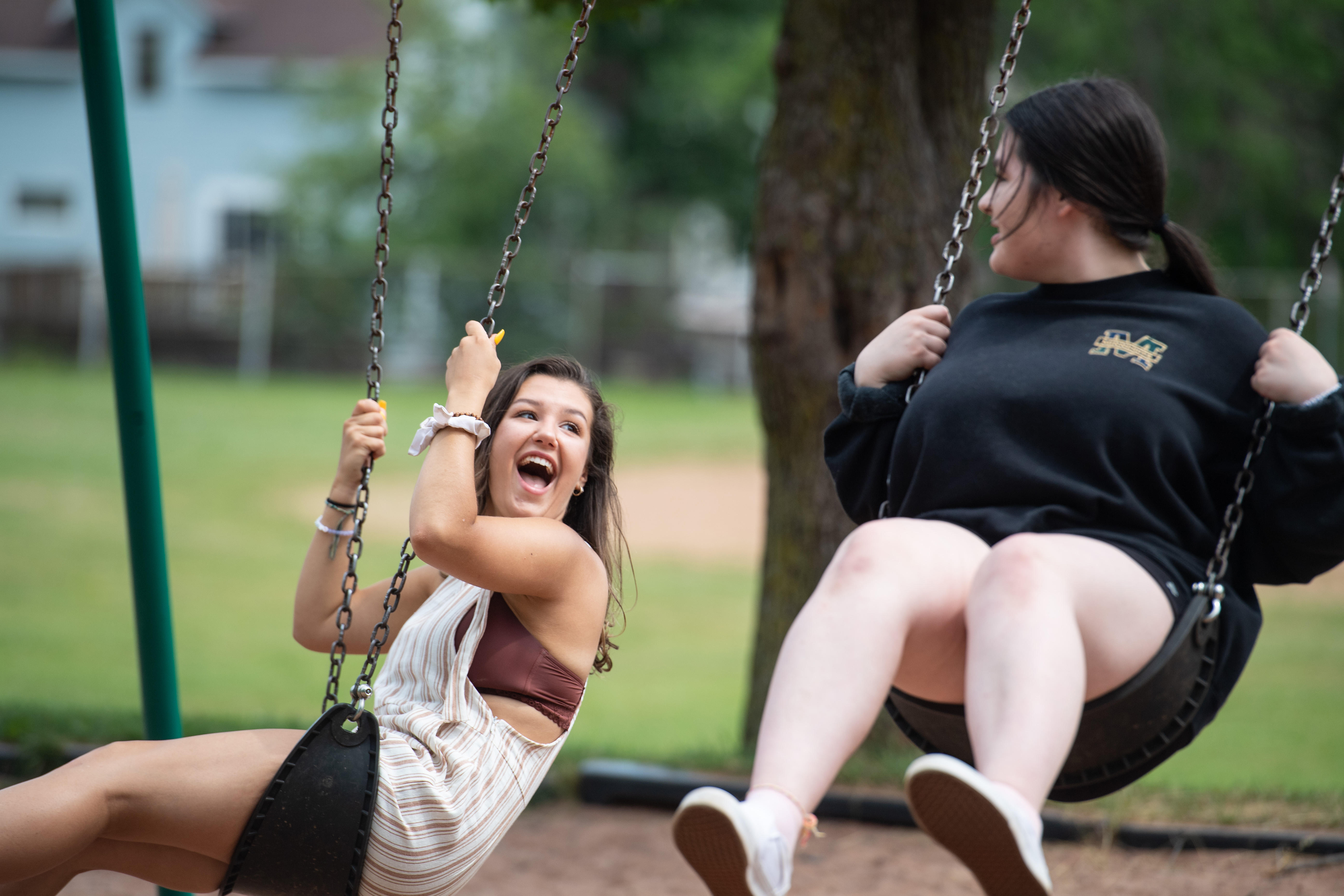 Freshman Lindsay with her sister on a swing
